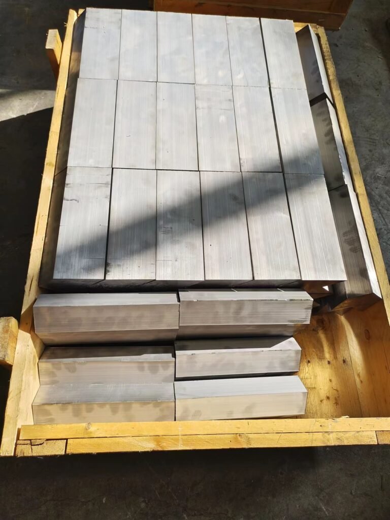 OSIDEK custom-machined square radiation shielding lead bricks arranged on a pallet, designed for specialized medical facility construction.