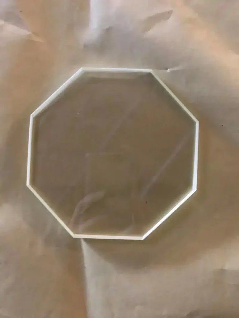 Octagonal custom-cut radiation shielding lead glass sheet by OSIDEK, showcasing precision manufacturing for specialized observation windows.
